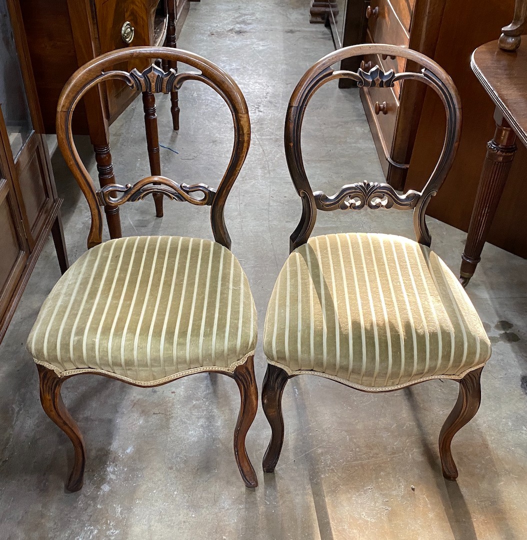 A set of four Victorian balloon back dining chairs